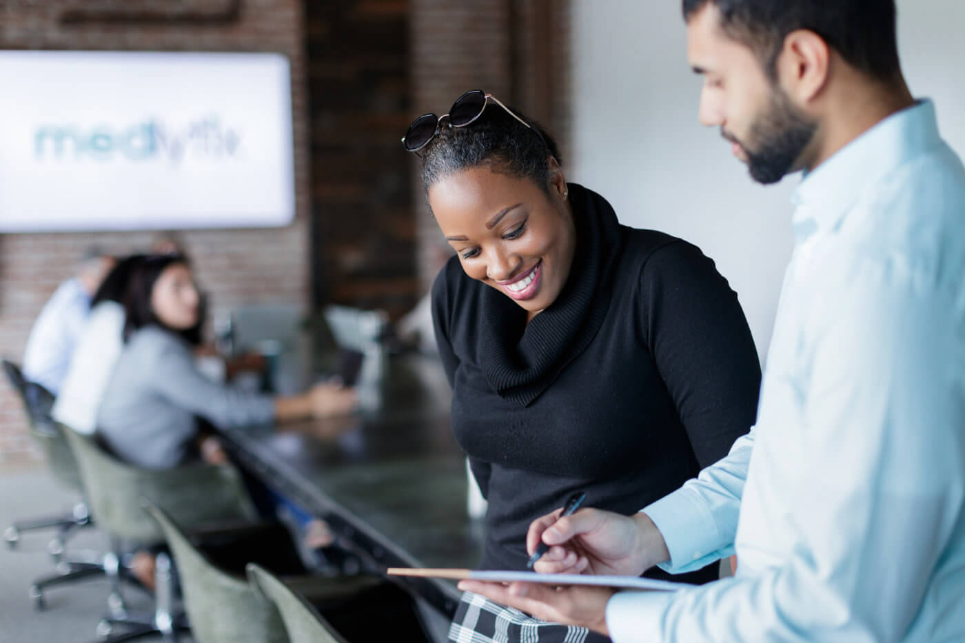 Coworkers Reviewing Data on Tablet